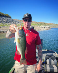 Andy holding a 4lb largemouth bass during his guided fishing trip at Lake Pleasant