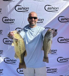 Daniel Elias holding two of his biggest fish in front of the Cashion rods banner for his 4th place finish at Bartlett Lake