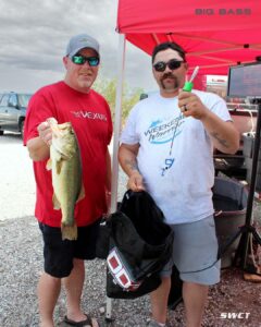 matt and daniel holding their 4lb bass in front of the scales at Alamo Lake