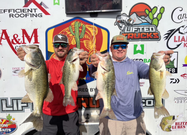 IMG_7232 Cameron and Kyle holding their winning fish in front of the FishIn48 trailer