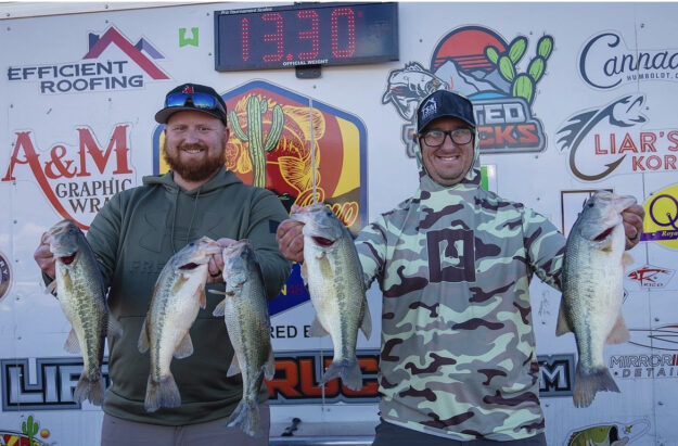 IMG_4218 Conrad & Shelby holding the winning the fish in front of the tournament trailer
