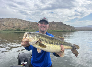 Client of Fishin48 holding a giant Largemouth bass at Saguaro Lake on a guided fishing trip 