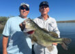 two clients holding an 8.4lb bass