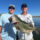 two clients holding an 8.4lb bass