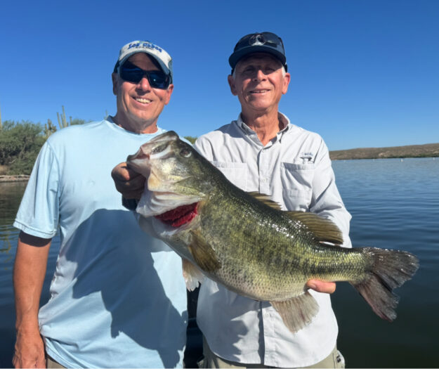 IMG_7845 two clients holding an 8.4lb bass