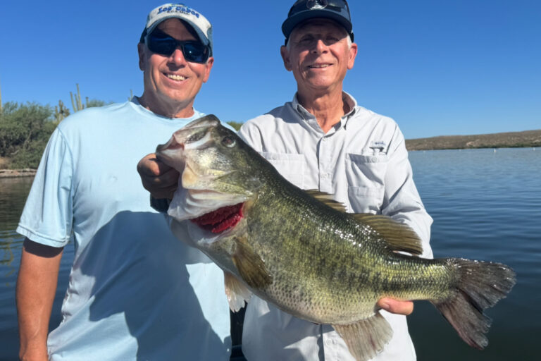 IMG_7845 two clients holding an 8.4lb bass